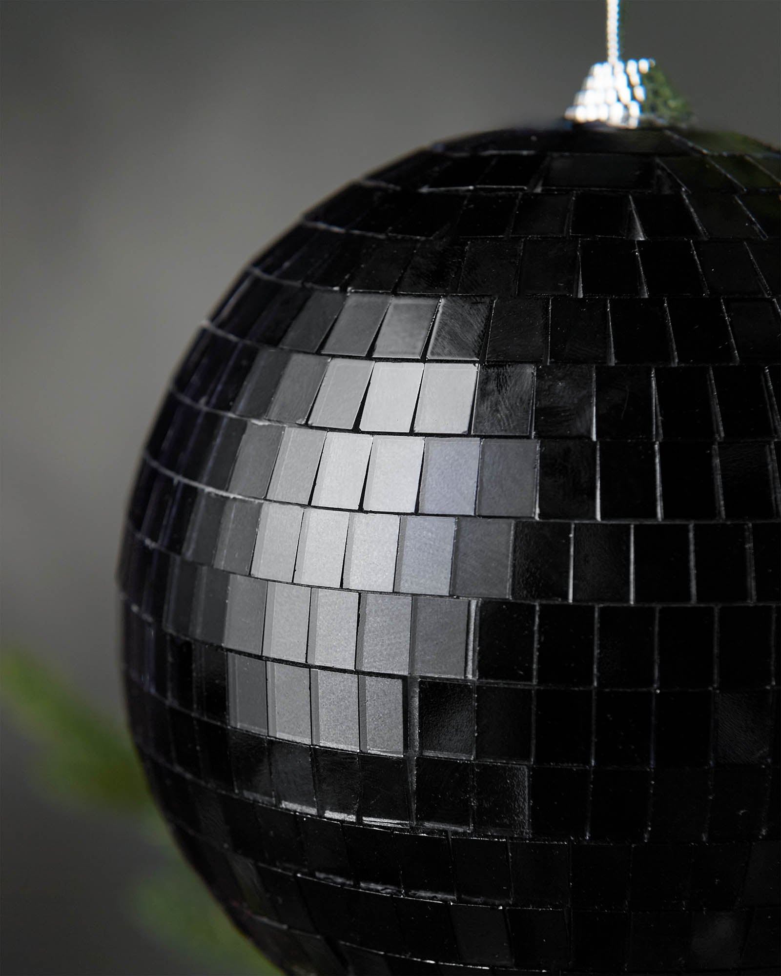 Close-up of a black 15cm disco ball bauble with mirrored square detailing.