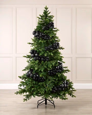 Black bauble cluster arch styled around a green Christmas tree with shiny, matt and glitter baubles.