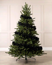 Black velvet bauble garland wrapped around a green Christmas tree with mixed 5cm, 7cm and 10cm baubles.