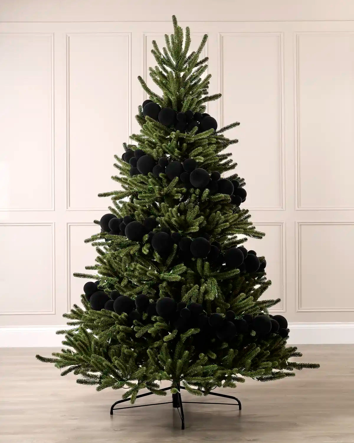 Black velvet bauble garland wrapped around a green Christmas tree with mixed 5cm, 7cm and 10cm baubles.