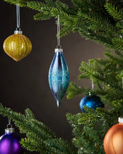 Blue glass teardrop bauble hanging on Christmas tree