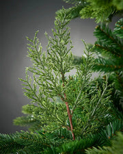 branch of artificial greenery against a dark background