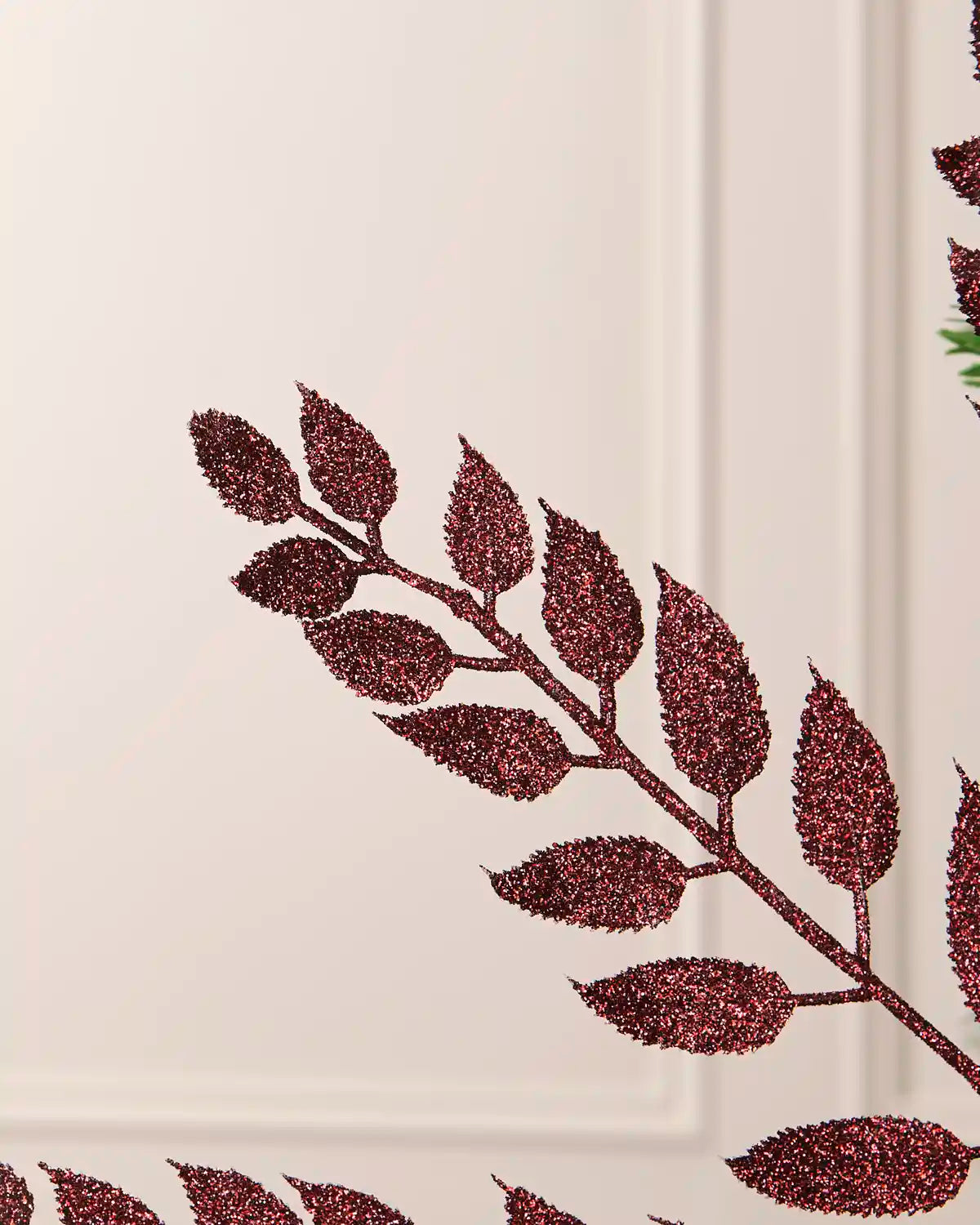 Detailed close-up of the sparkling burgundy leaves on a 73 cm Christmas tree spray.