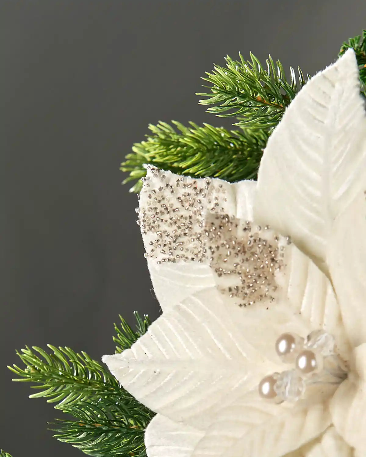 Close-up of a 27 cm cream artificial poinsettia flower showing beaded petal tips and textured fabric leaves.