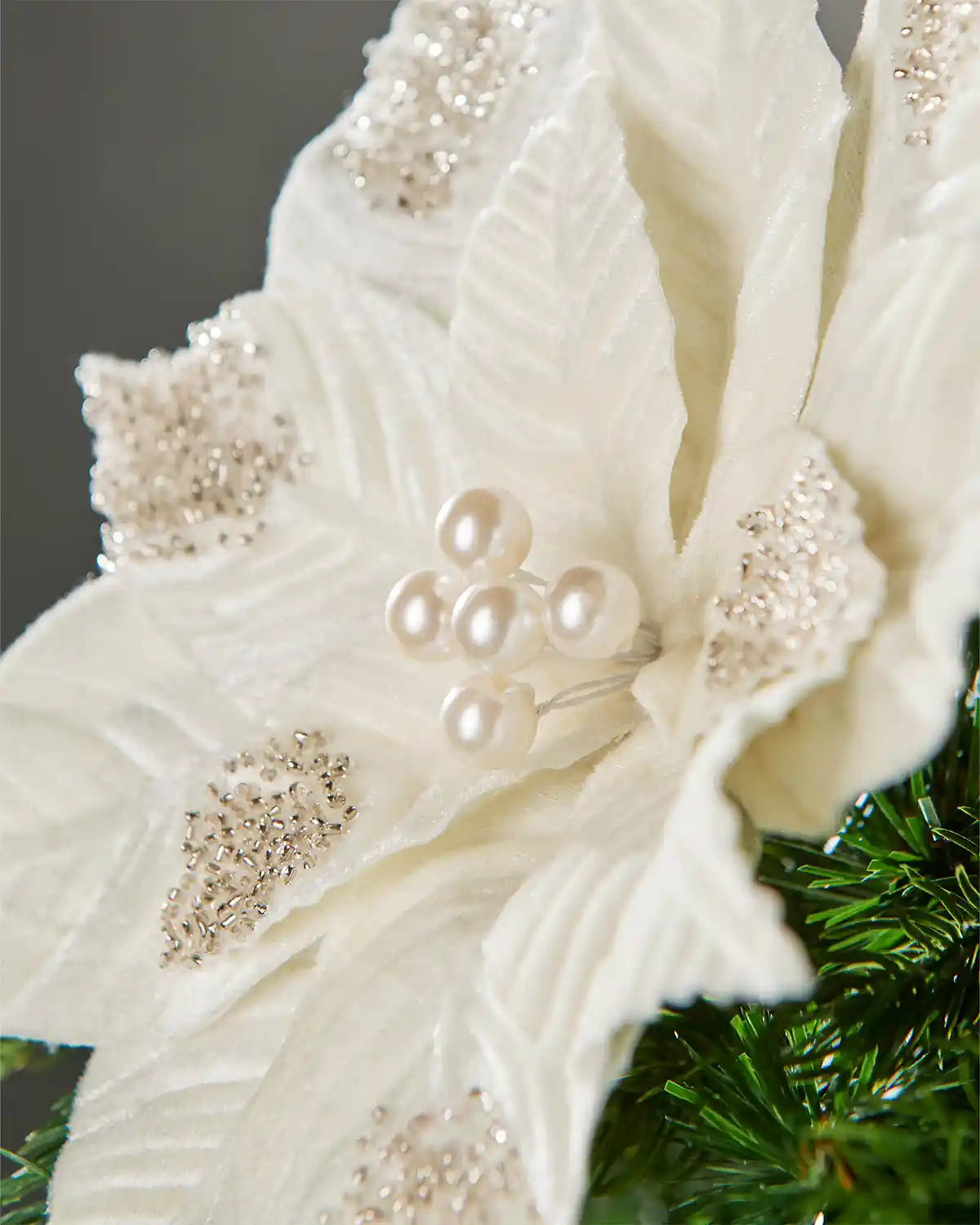 Close-up of a 27 cm cream artificial poinsettia flower with pearl-style centre and beaded detailing.