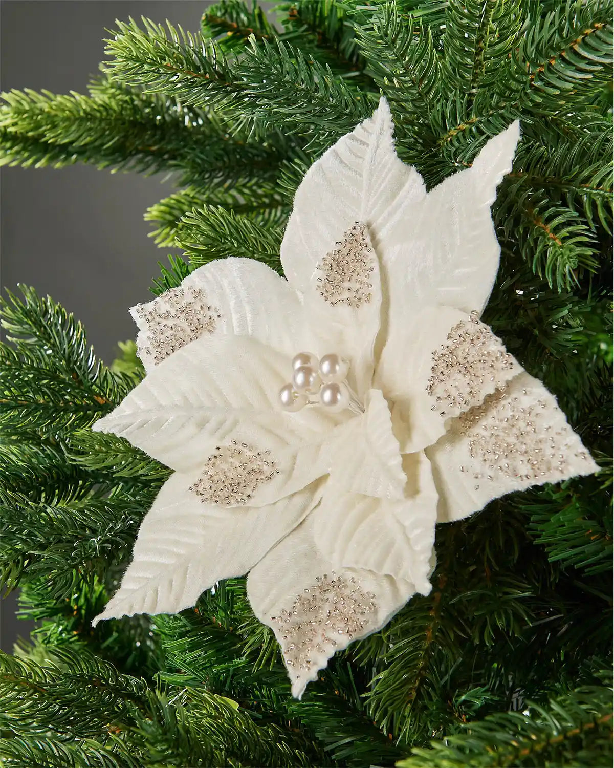 27 cm cream artificial poinsettia flower displayed in a Christmas tree, with beaded petal details and pearl-style centre.