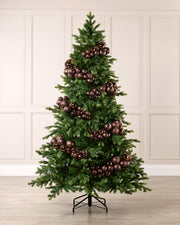 Espresso bauble cluster arch arranged around a green Christmas tree with shiny, matt and glitter baubles.