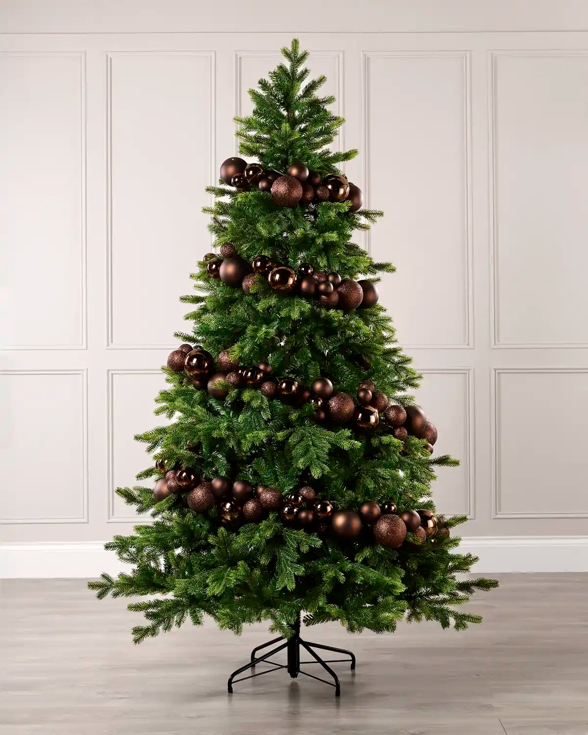 Espresso bauble garland wrapped around a green Christmas tree with shiny, matt and glitter baubles.