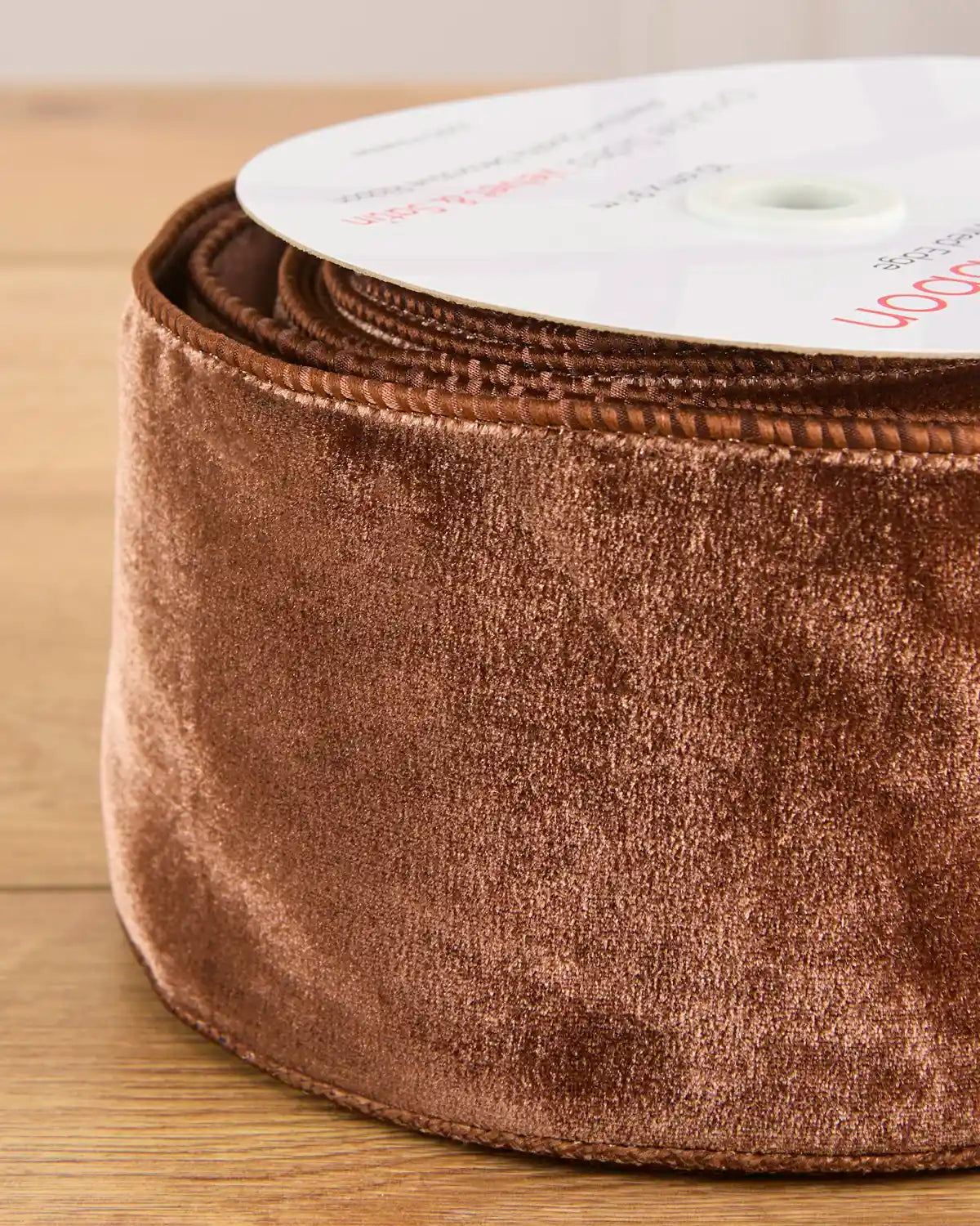 Close-up of 10 cm wide espresso velvet ribbon showing its soft surface and wired edges.