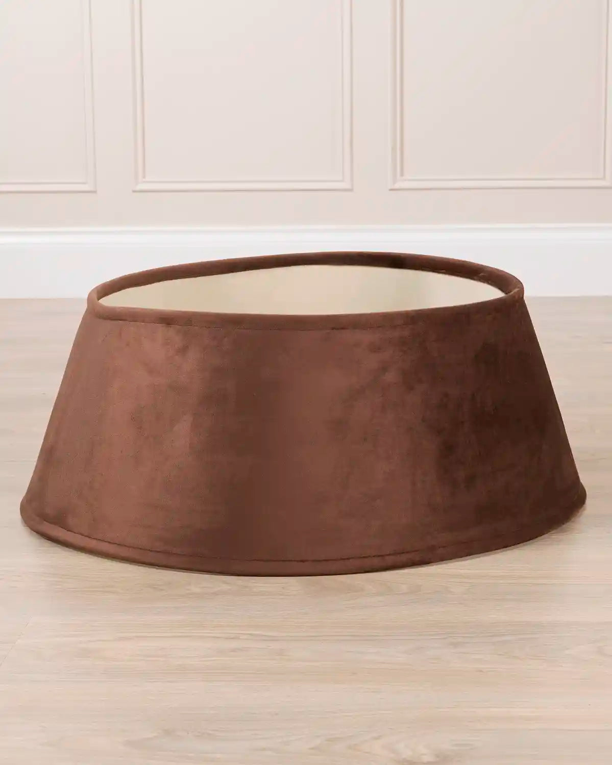 espresso velvet tree skirt displayed by itself, showing its circular shape, flared silhouette, and open center.
