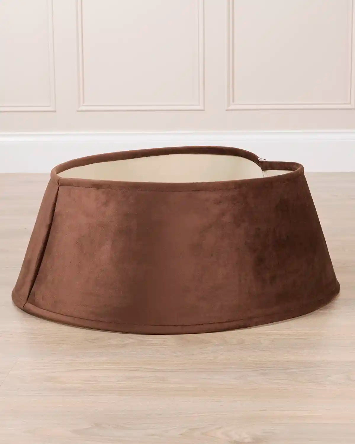 espresso velvet tree skirt displayed by itself, showing its circular shape, flared silhouette, and open center.