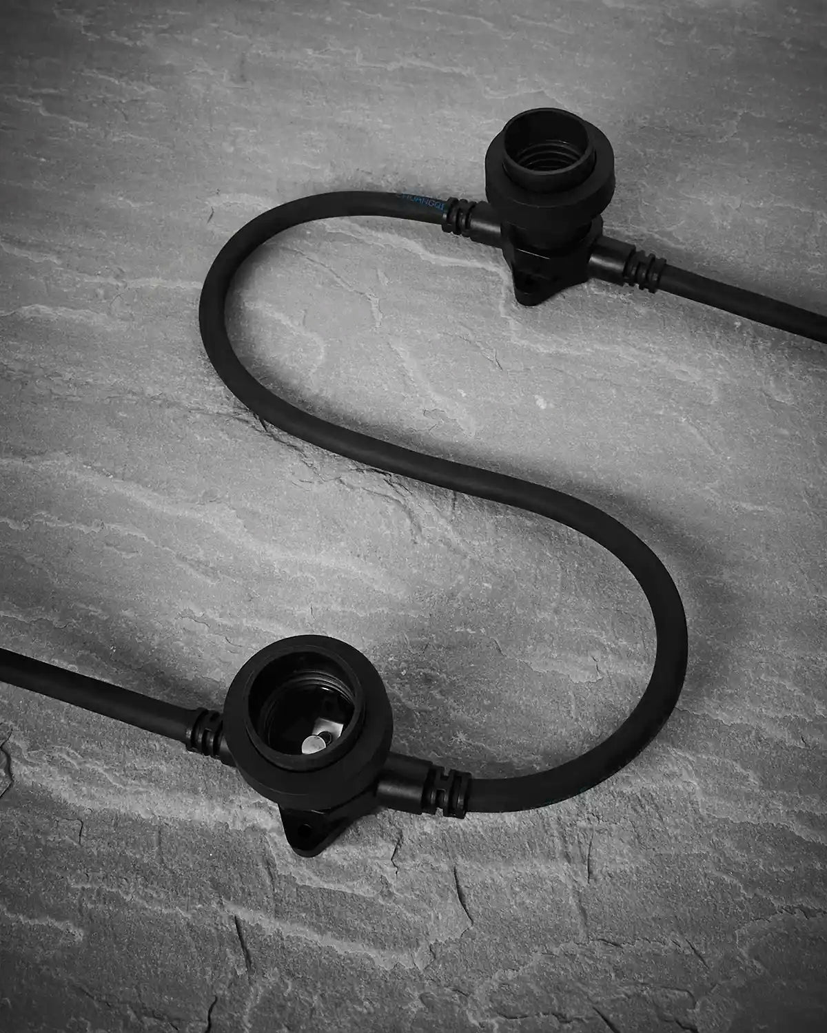 Black E27 festoon belt sockets shown on a grey surface without bulbs fitted.