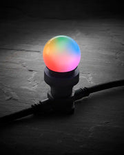 Colour-changing E27 LED festoon bulb glowing with rainbow colours in a black festoon socket.