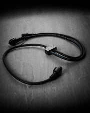 Black Festoon Series connectable Y cord connector on a grey surface.