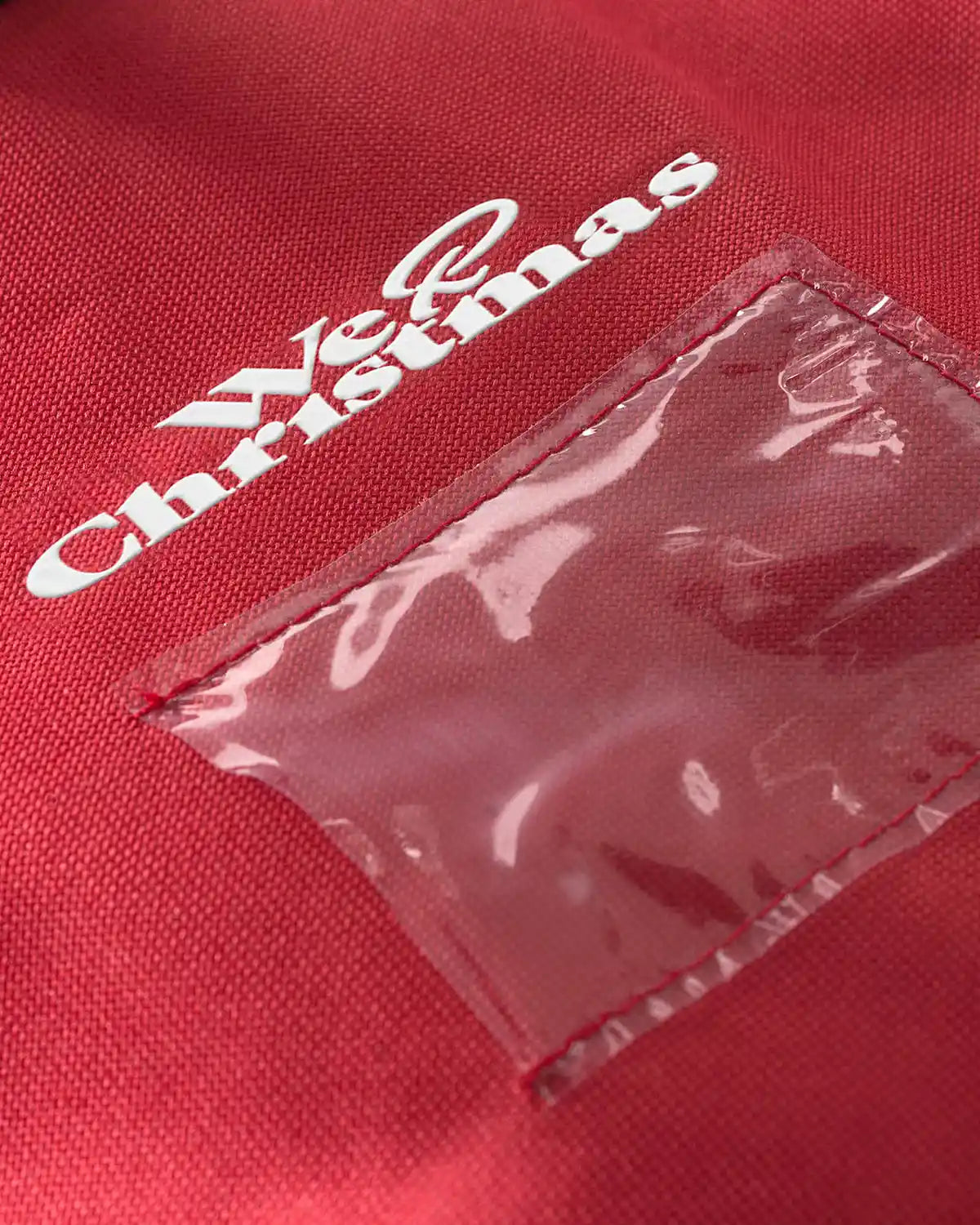 Close-up of the clear label pocket on the red storage bag