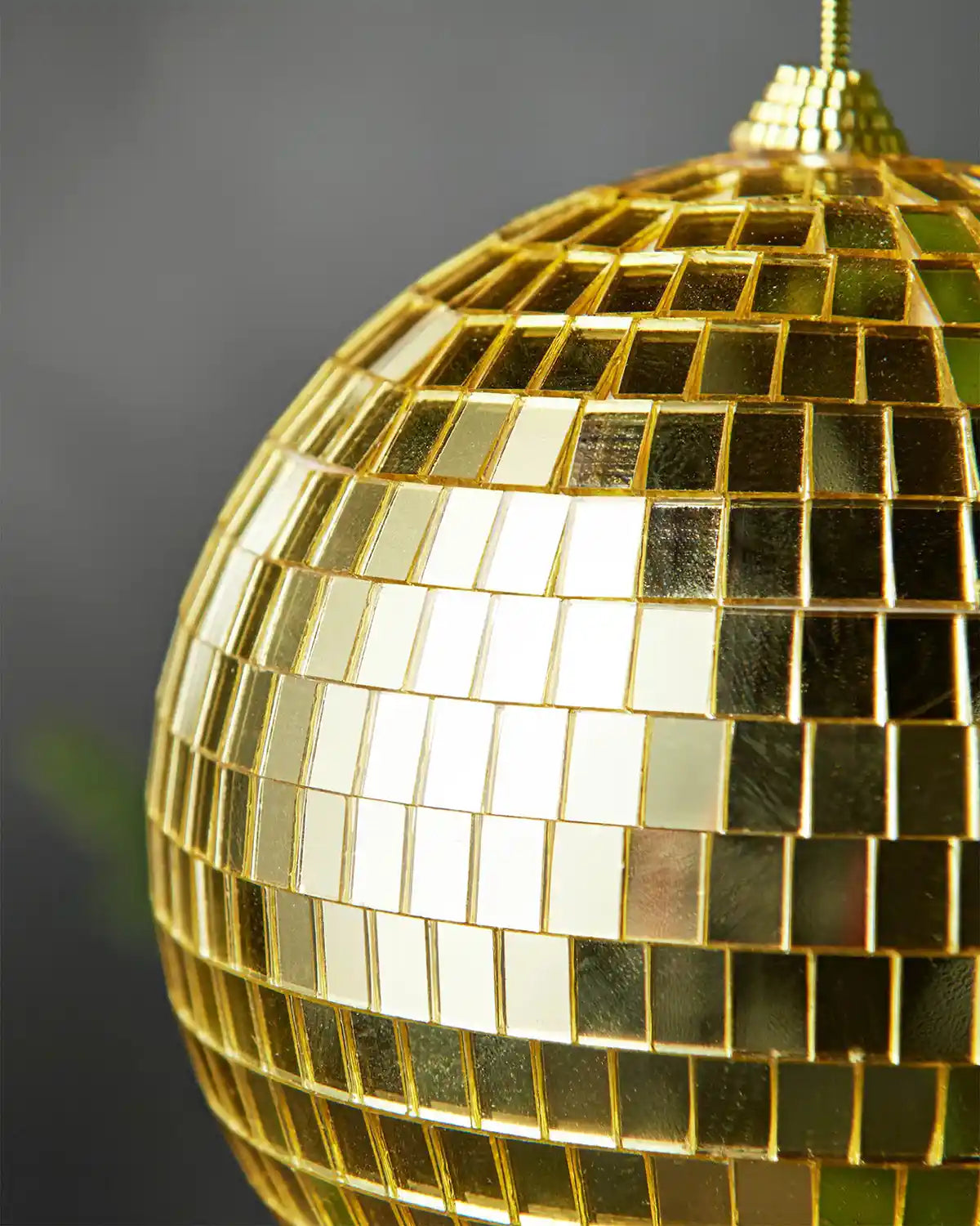 Close-up of a gold 15cm disco ball bauble with mirrored square detailing.