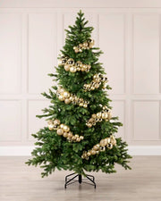 Gold bauble cluster arch styled around a green Christmas tree with shiny, matt and glitter baubles.