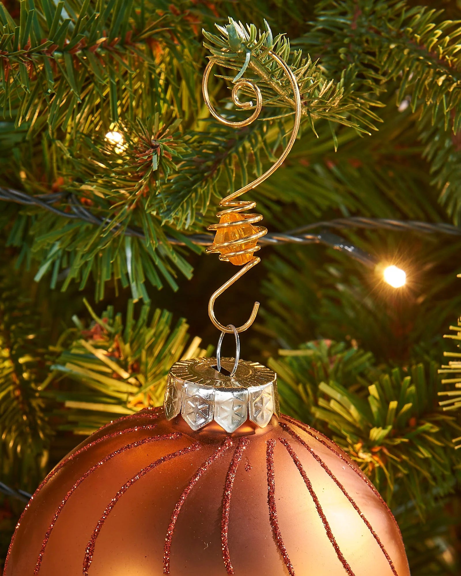 Gold gemstone bauble hook hanging a bauble on a Christmas tree branch