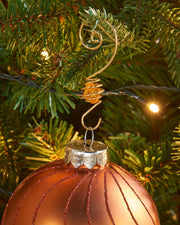 Gold gemstone bauble hook hanging a bauble on a Christmas tree branch