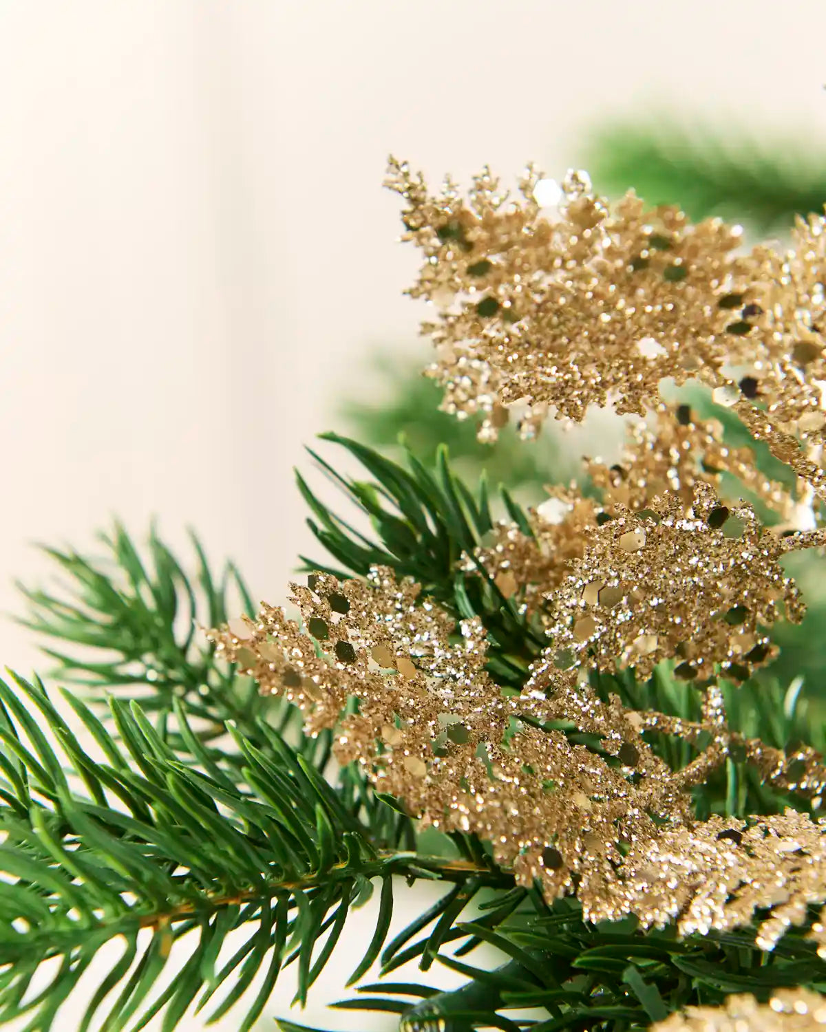 Close-up of gold glitter leaf shapes showing textured surfaces and reflective sequin details.
