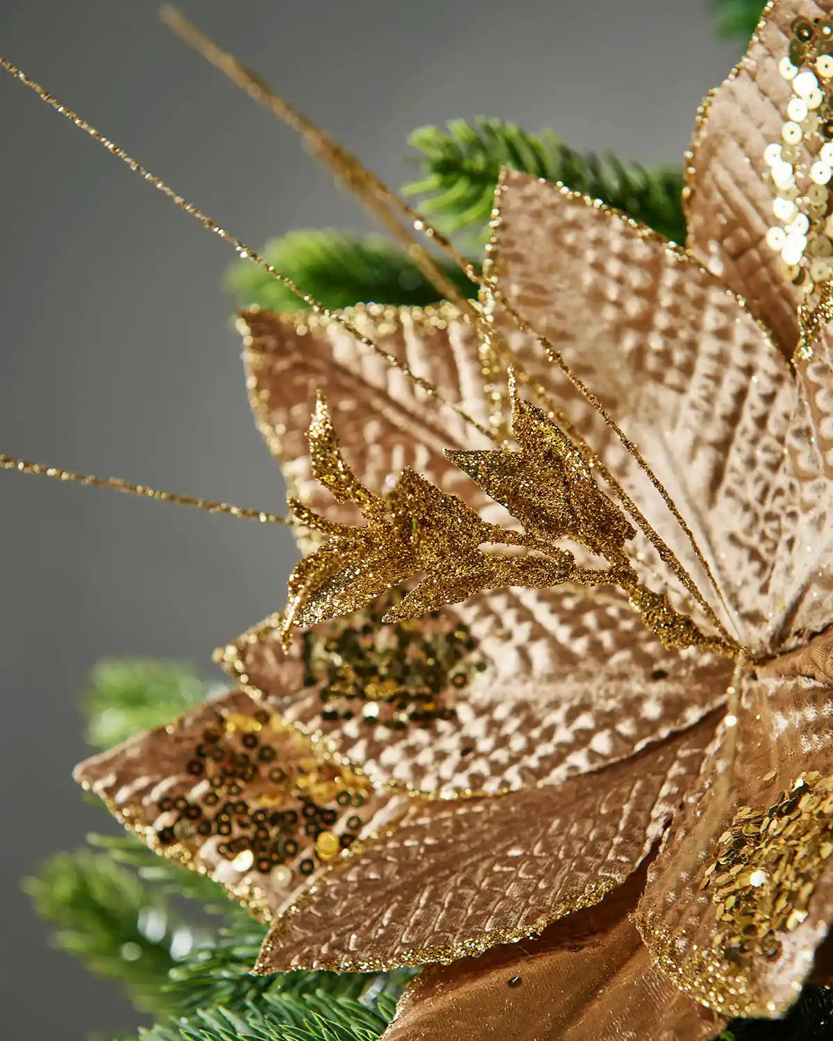 Close-up of the glittered centre and wired accents on the gold poinsettia