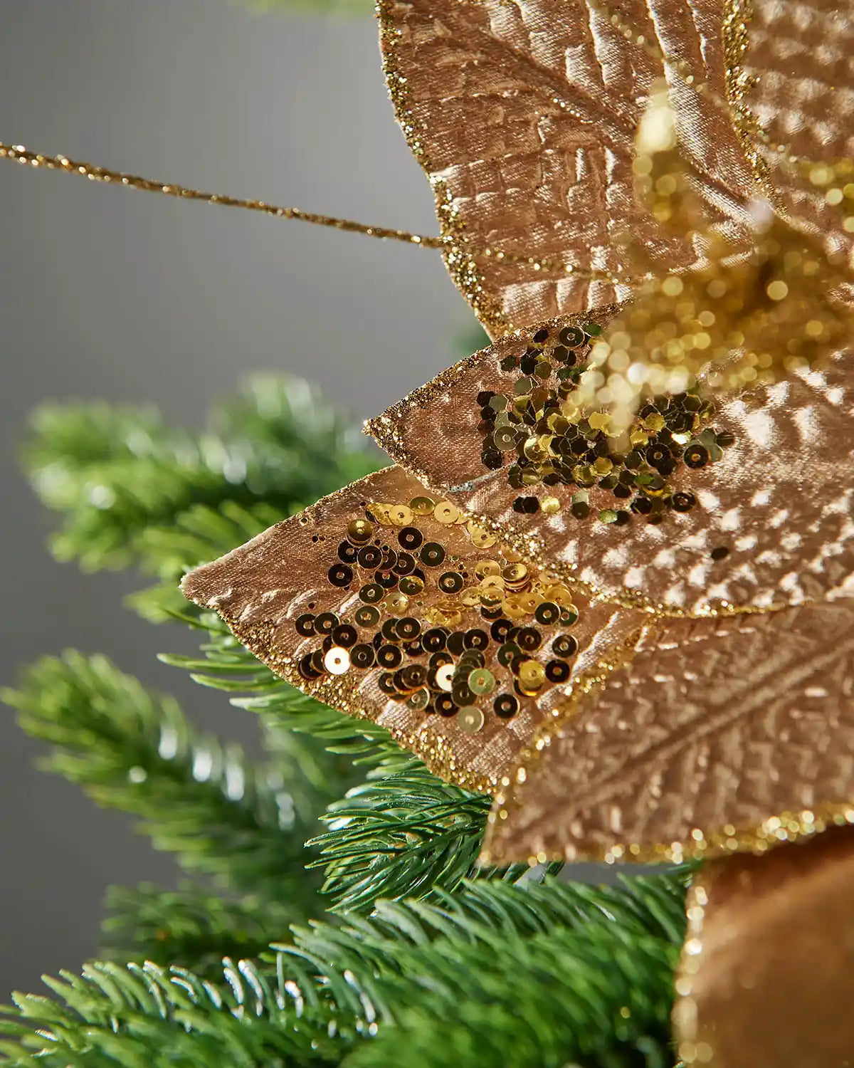 Close-up of the gold sequin and glitter detailing on the poinsettia petals