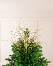 Gold 90 cm glitter twig tree topper arranged at the top of a Christmas tree.
