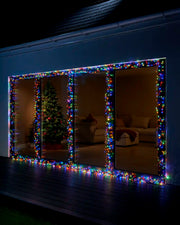 Multi colour Home Series cluster lights displayed around large patio doors at night.