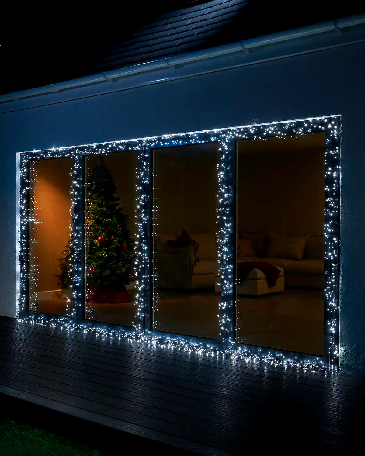 White Home Series cluster lights displayed around large patio doors at night.