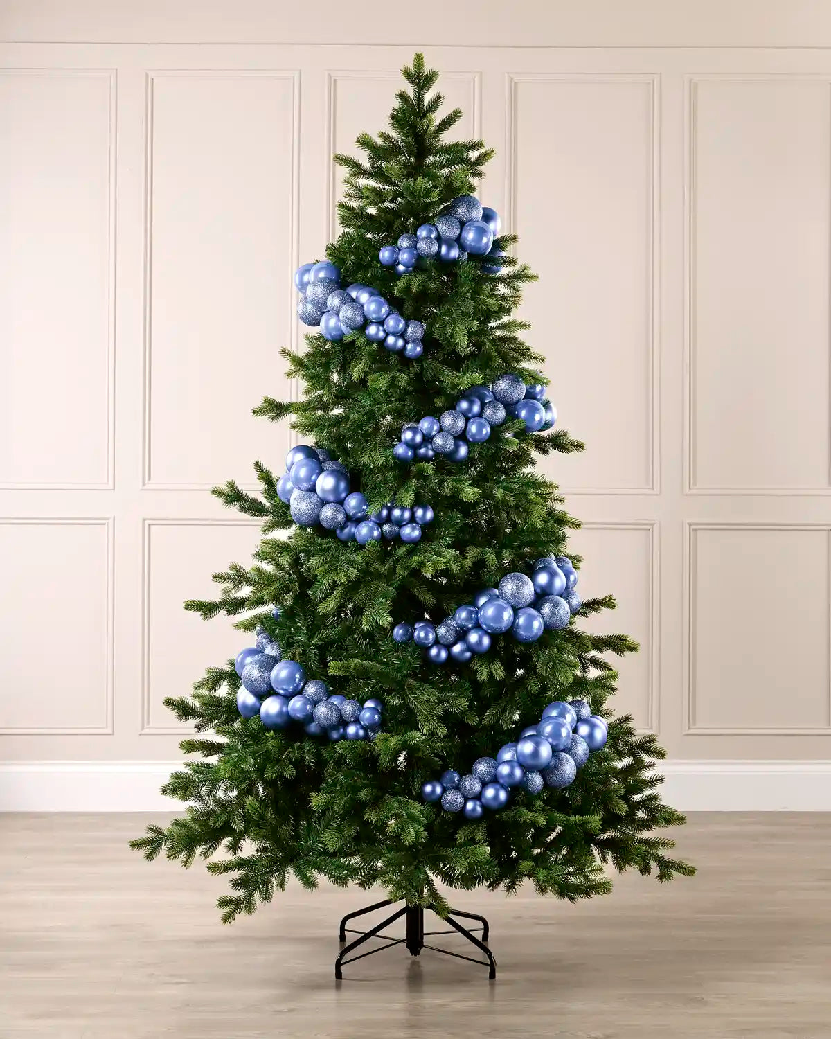 Ice blue bauble cluster arch styled around a green Christmas tree with shiny, matt and glitter baubles.