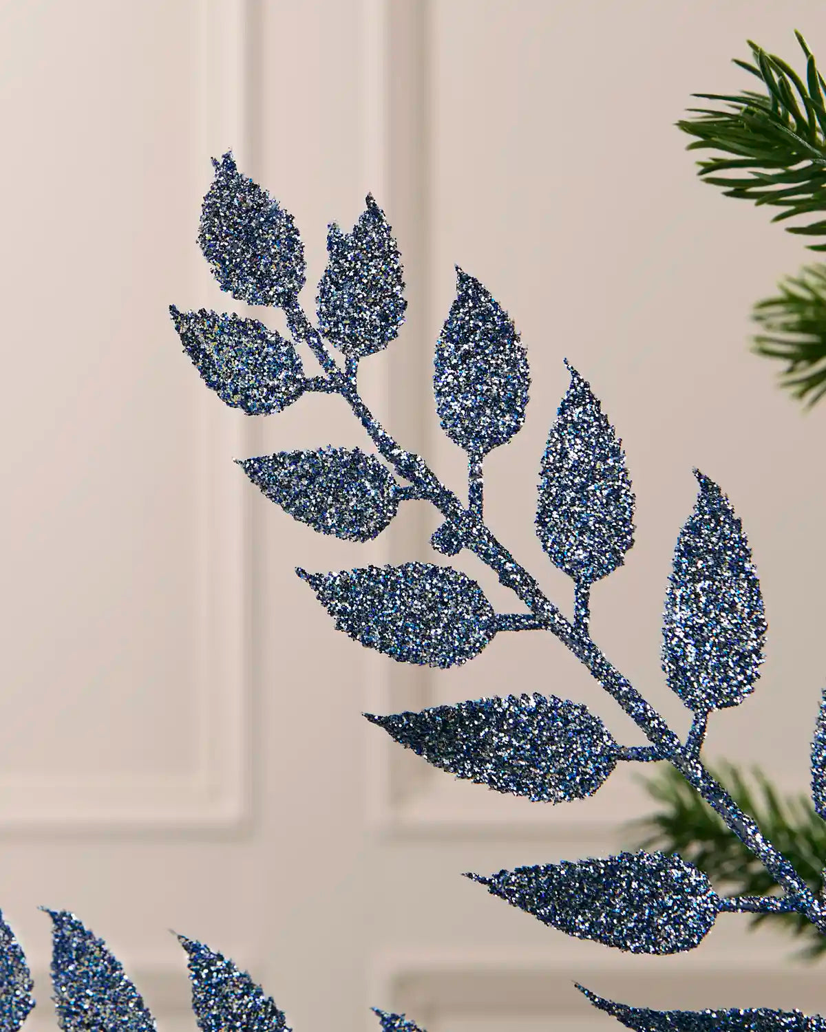 Detailed close-up of the sparkling ice blue leaves on the 73 cm Christmas tree spray.