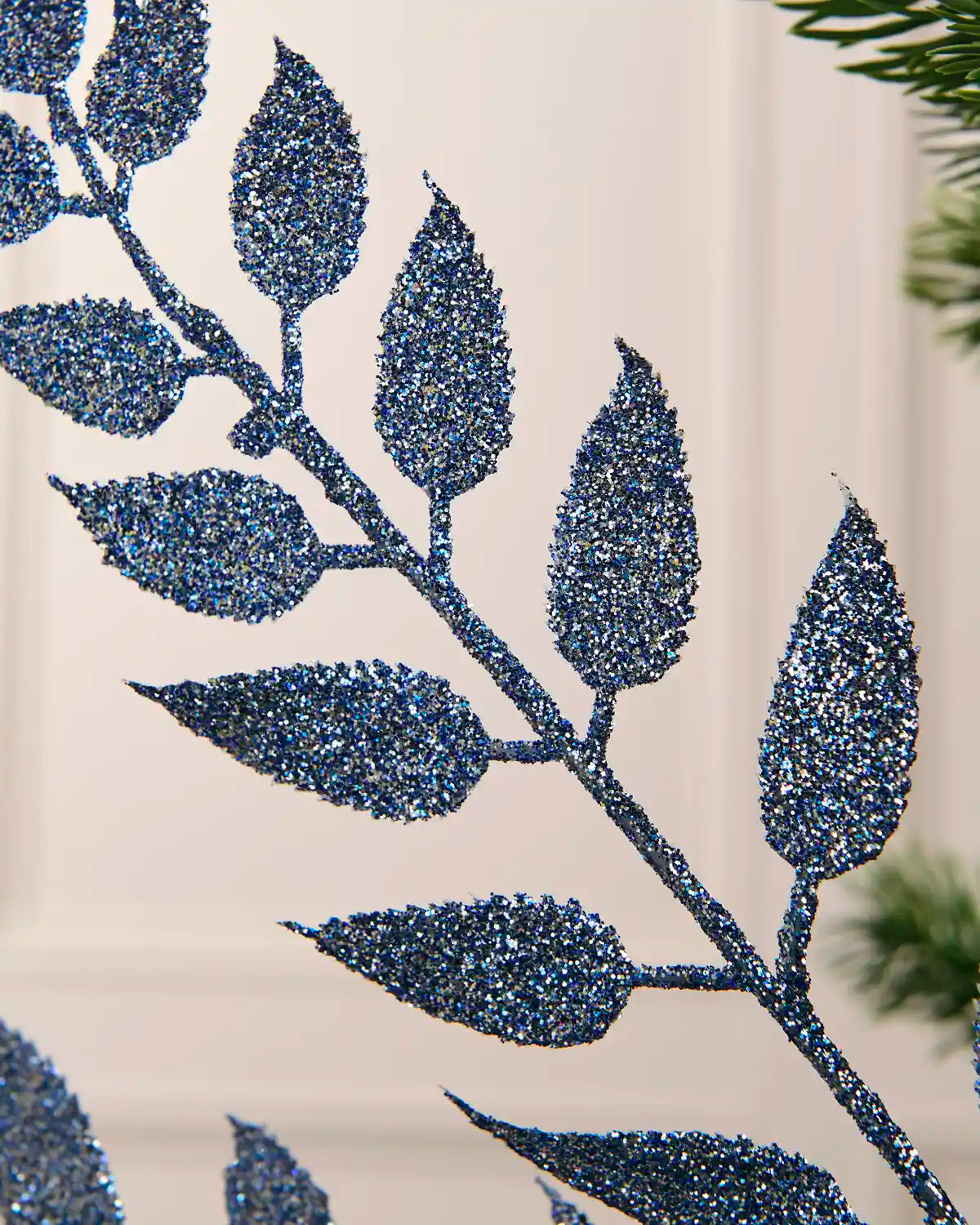 Close-up of the glitter-coated ice blue leaves on the Christmas tree spray.
