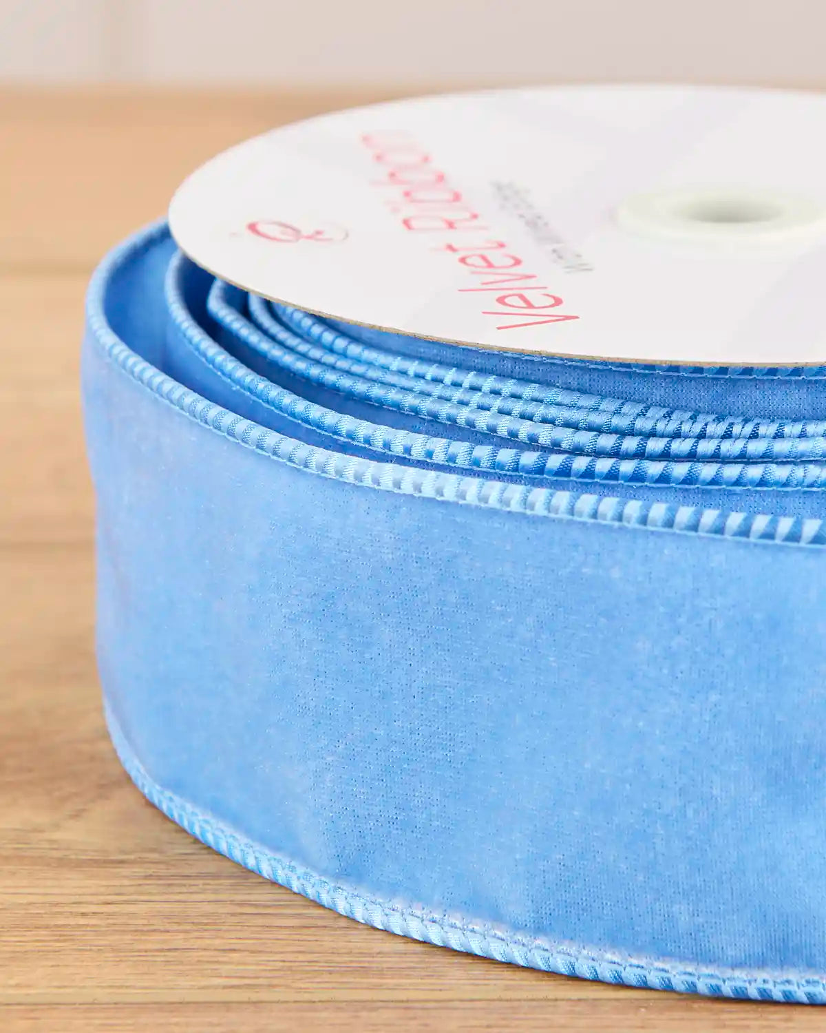 Close-up of the ice blue velvet ribbon showing the soft fabric and wired edging.