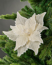 30 cm ivory artificial poinsettia flower displayed in a Christmas tree, with layered fabric petals and white glitter trim.