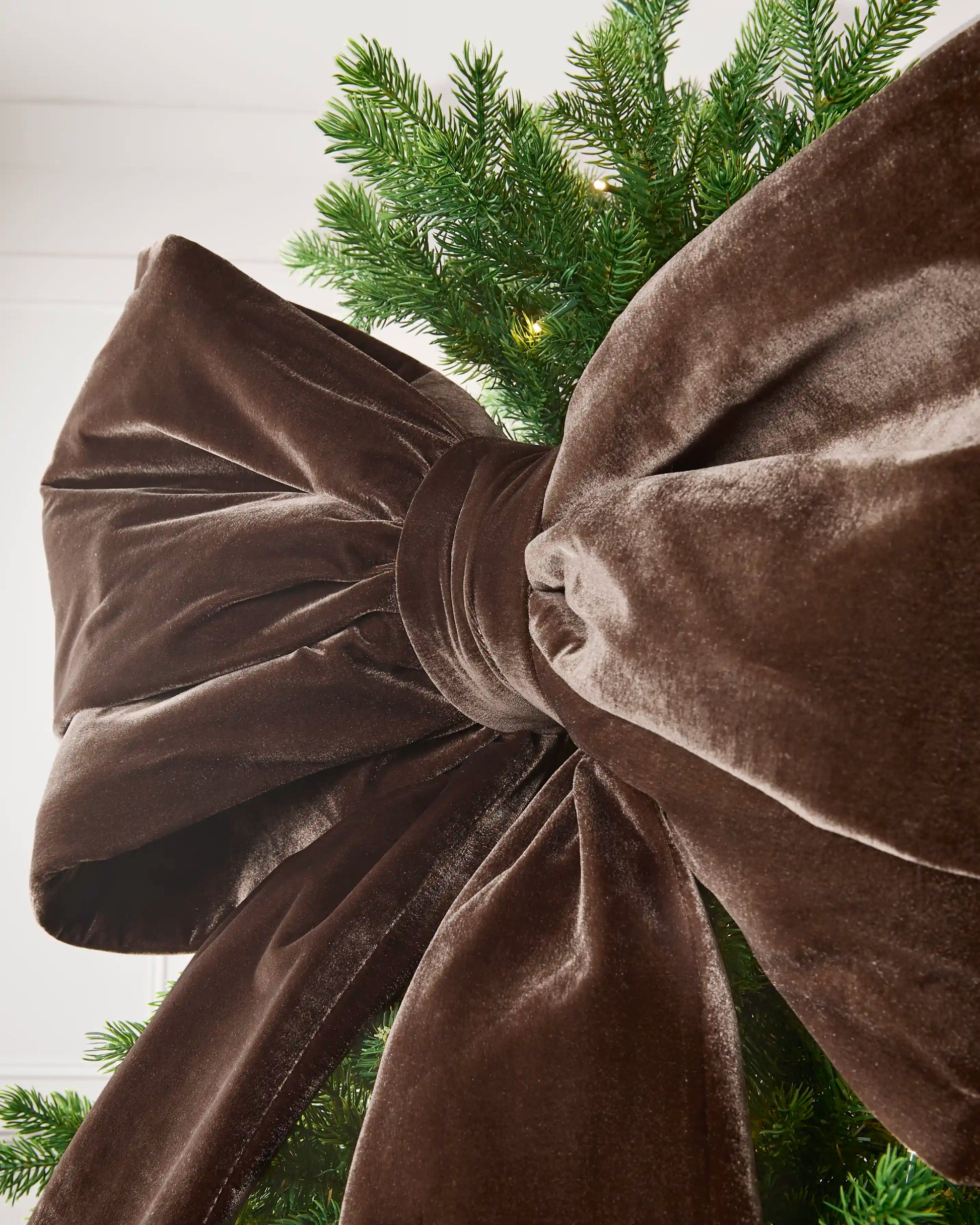Close-up of the large espresso velvet Christmas bow showing its full structured loops and soft finish.