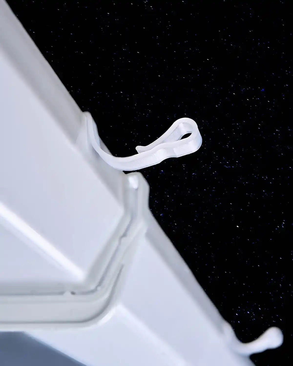 White large gutter hook clipped onto guttering