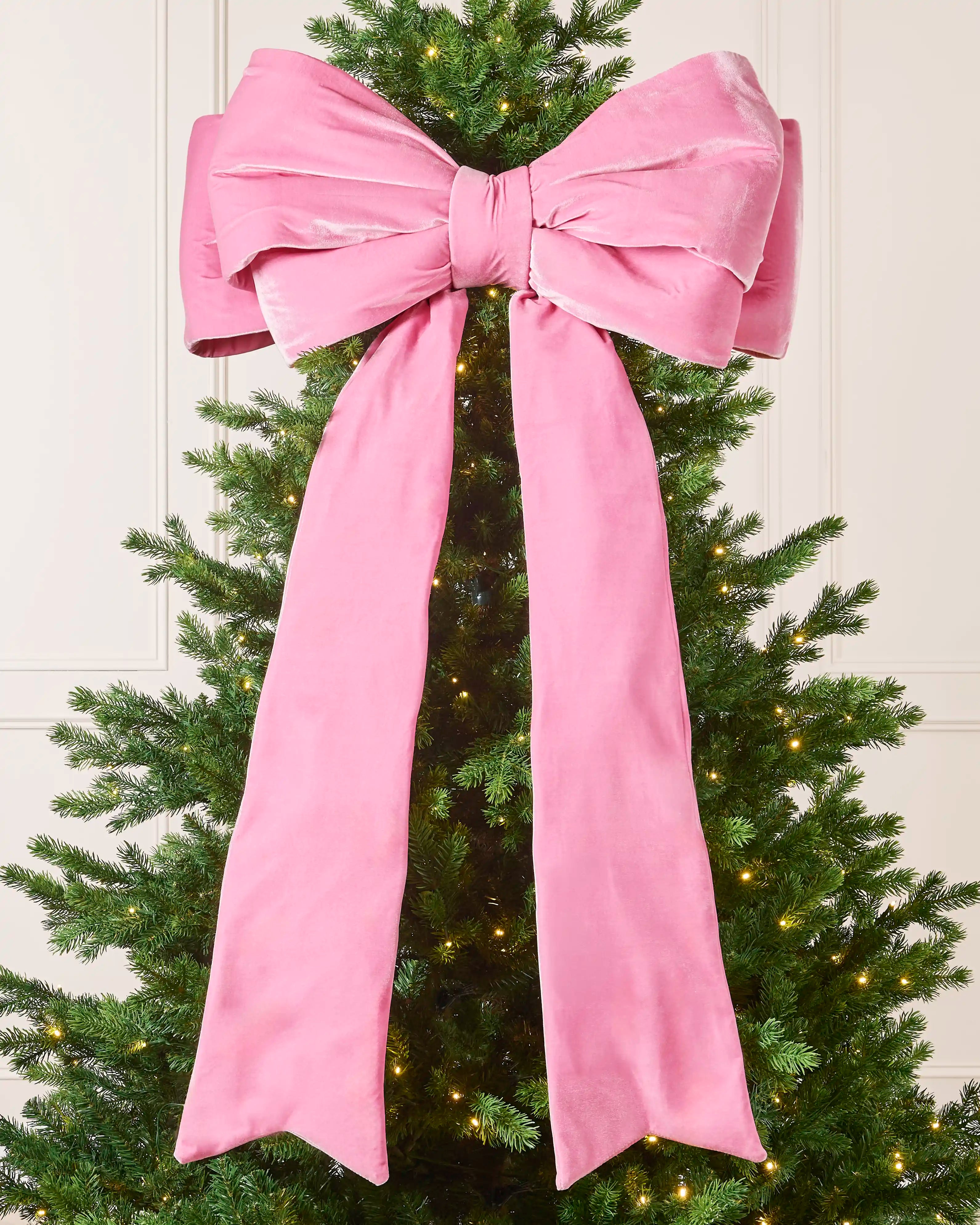 Large 140 cm pink velvet Christmas bow displayed on a decorated Christmas tree.