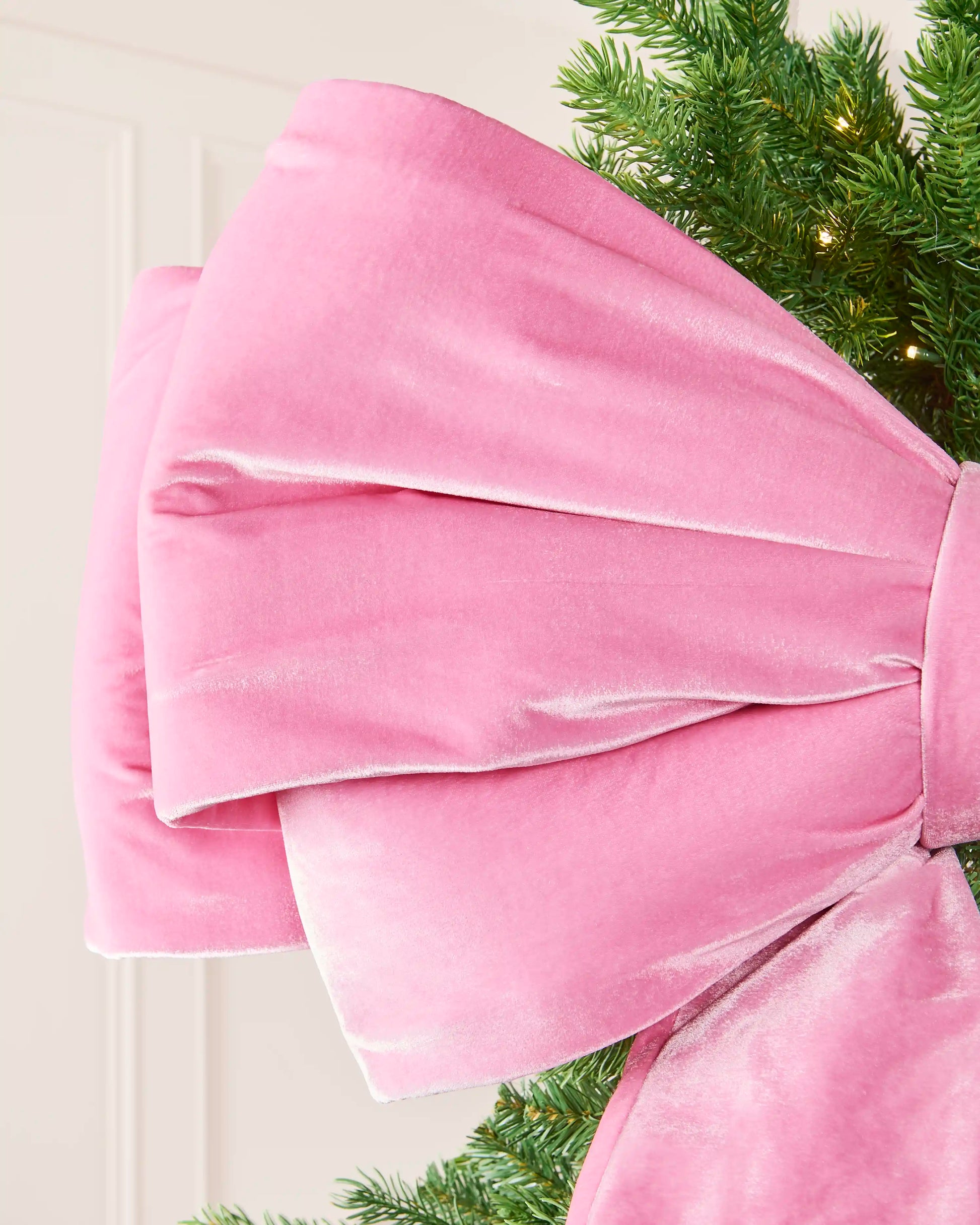 Detailed view of the soft pink velvet loops on the large Christmas bow.