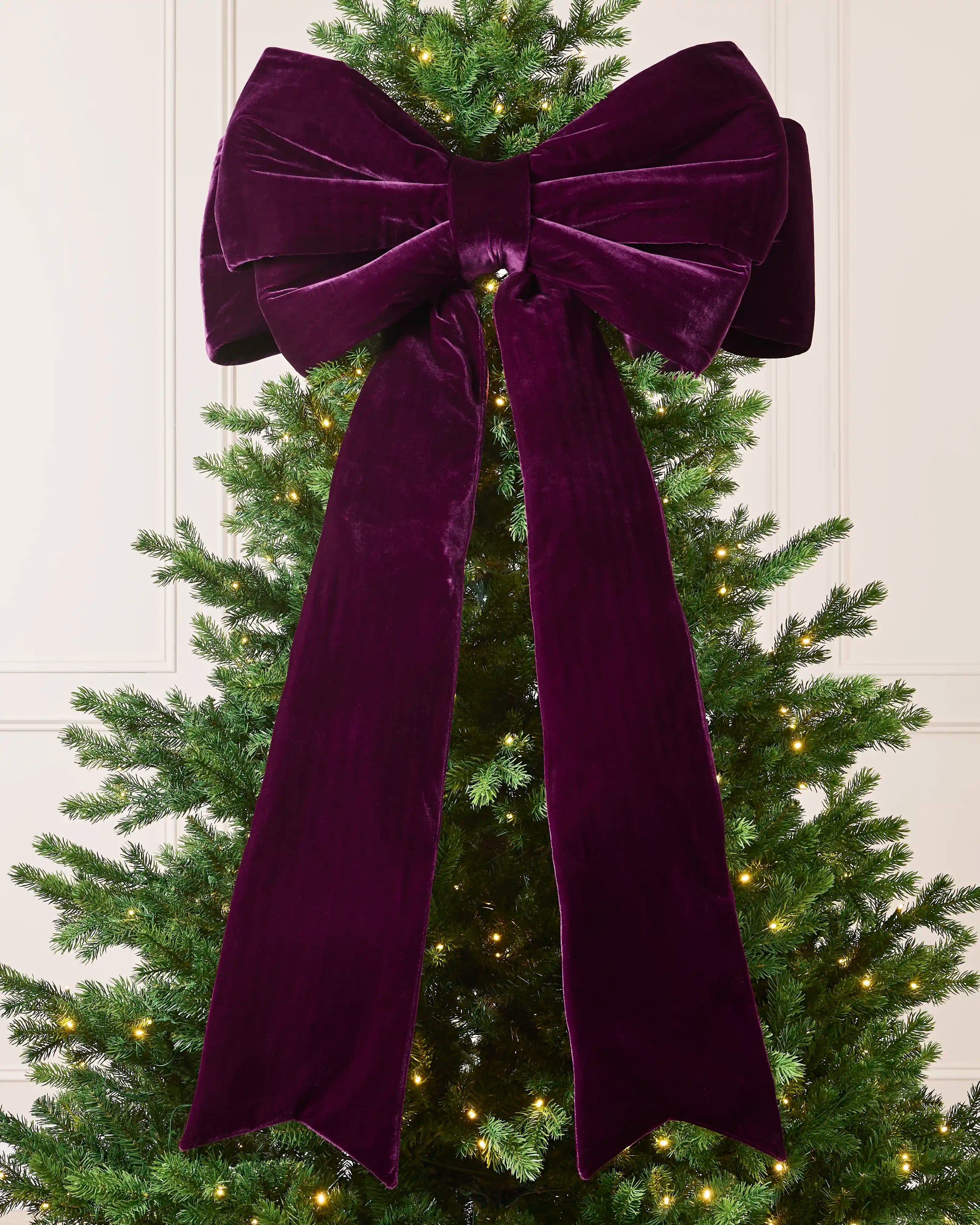 Large 140 cm purple velvet Christmas bow displayed on a decorated Christmas tree.