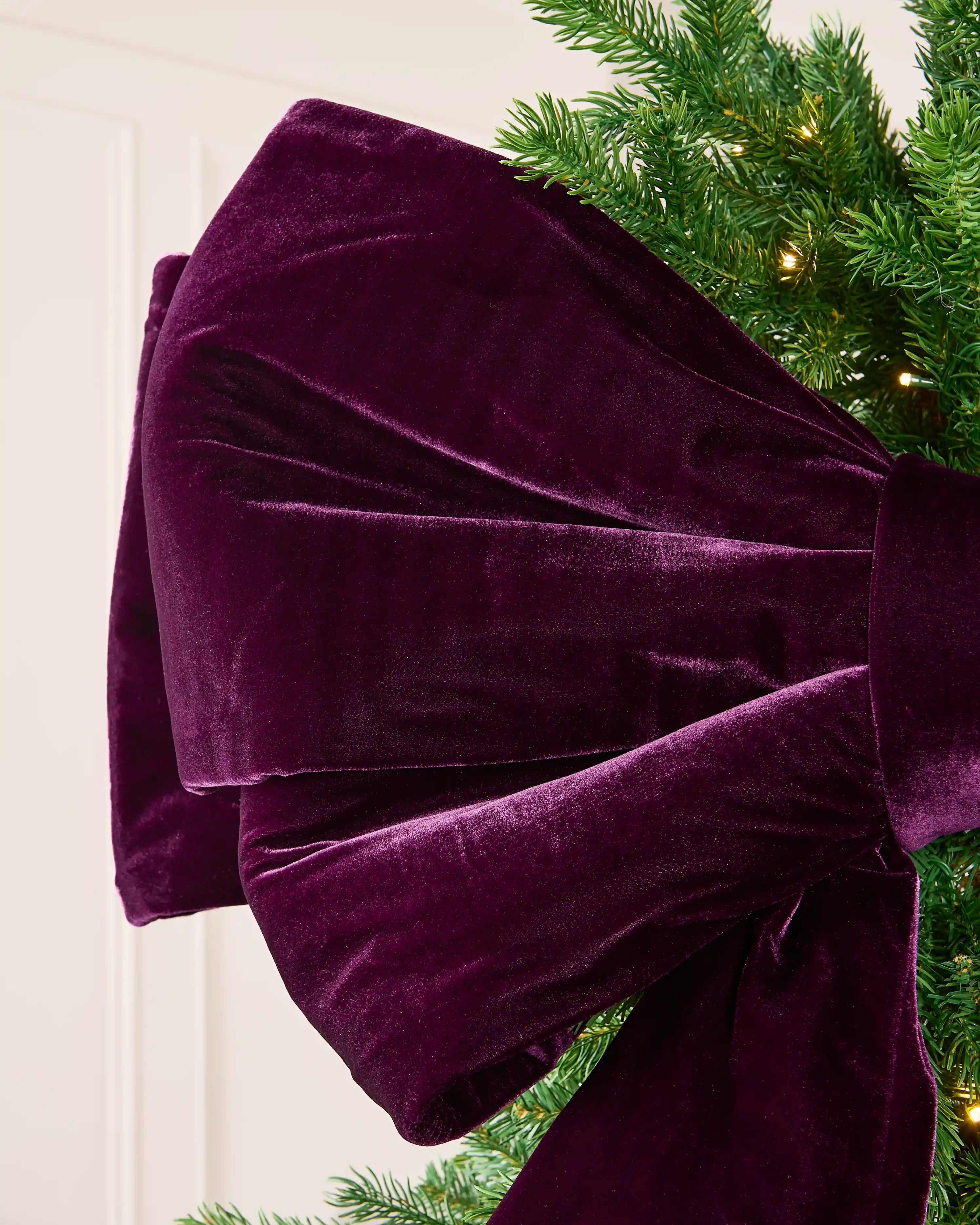 Detailed view of the soft purple velvet loops on the large Christmas bow.