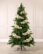Latte bauble cluster arch styled around a green Christmas tree with shiny, matt and glitter baubles.