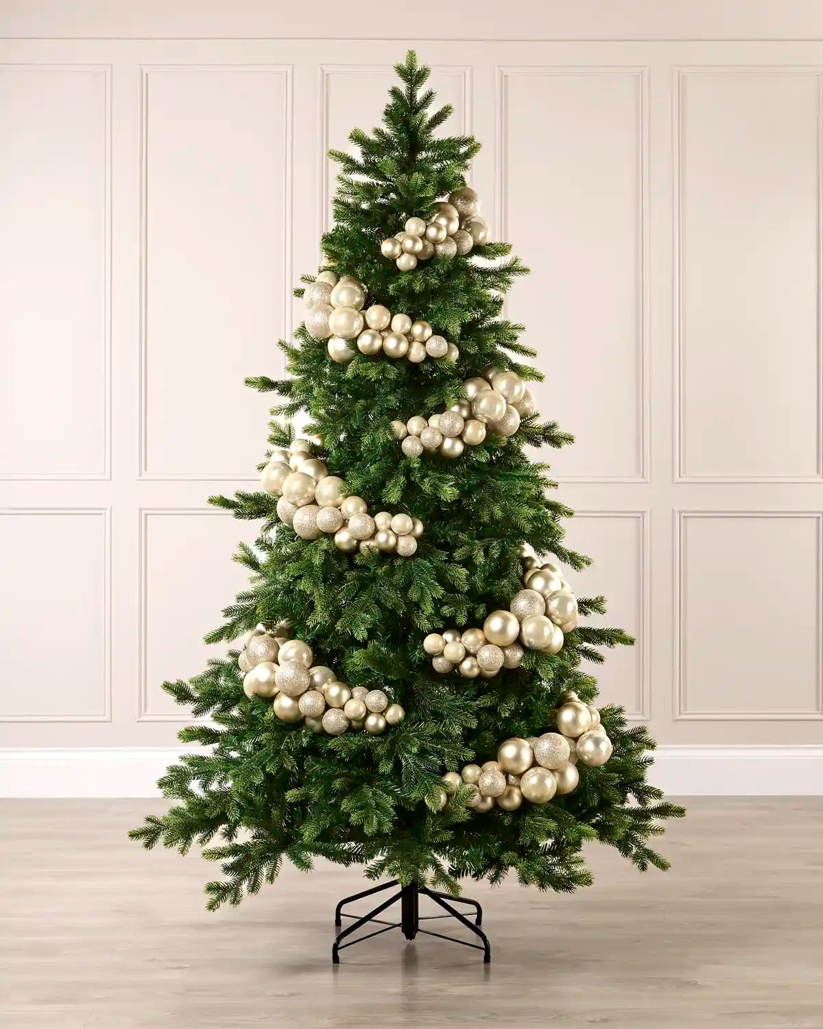 Latte bauble cluster arch styled around a green Christmas tree with shiny, matt and glitter baubles.