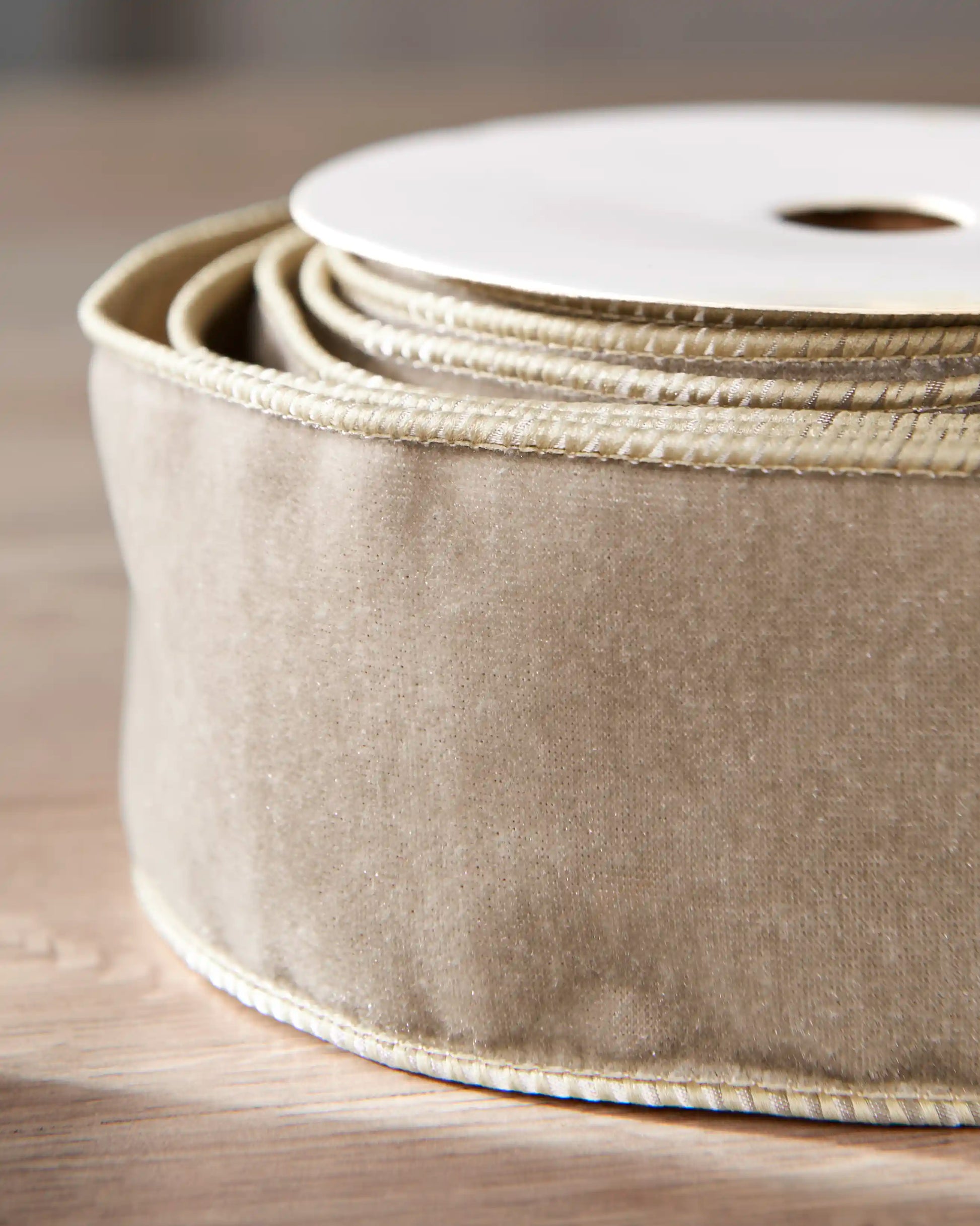 Close-up of 6 cm latte double-sided wired velvet ribbon showing the soft velvet surface and wired edges.