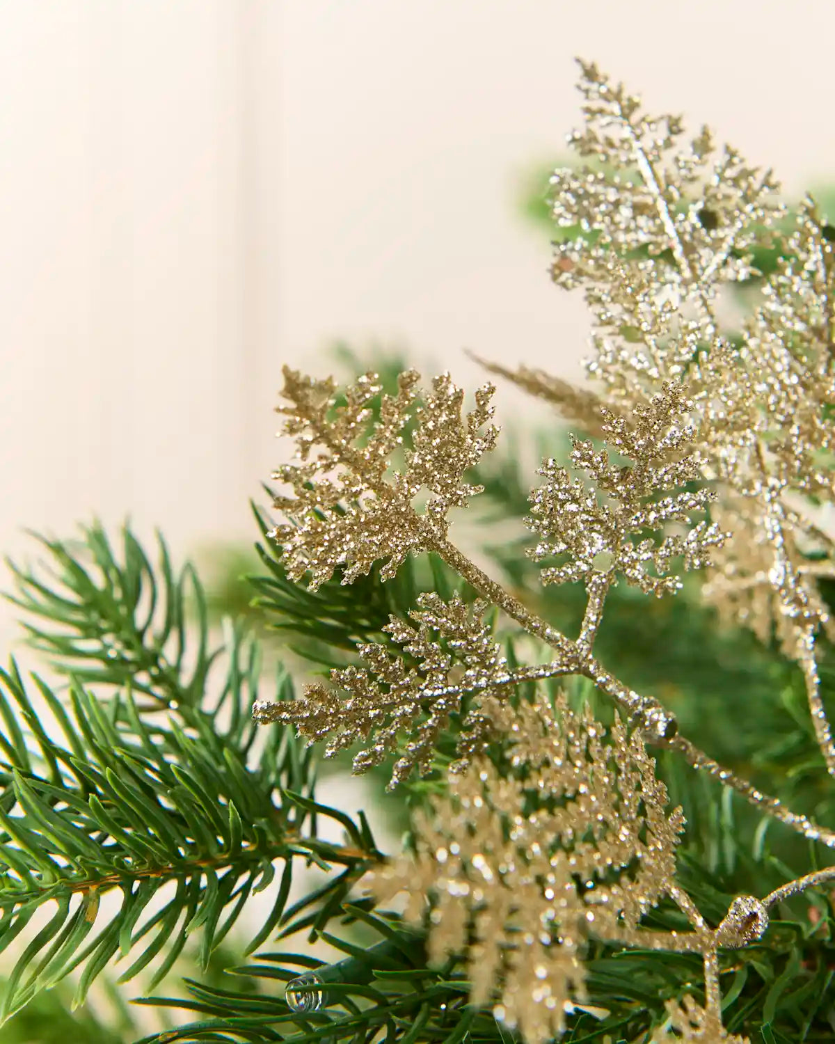 Close-up of latte glitter leaves with fine branching details and a light-catching finish.