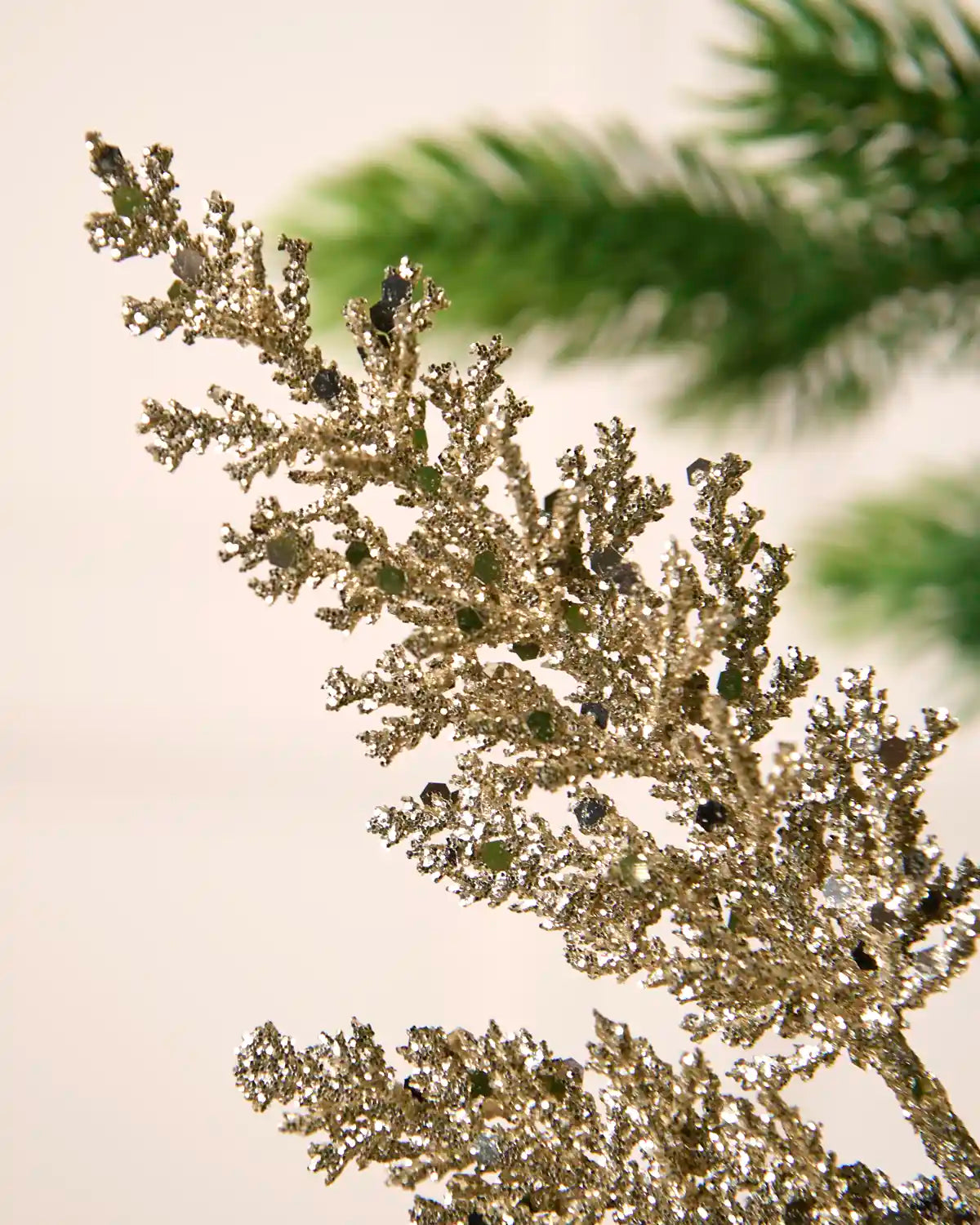 Close-up of latte glitter leaf foliage with reflective sequins and a sparkling finish.