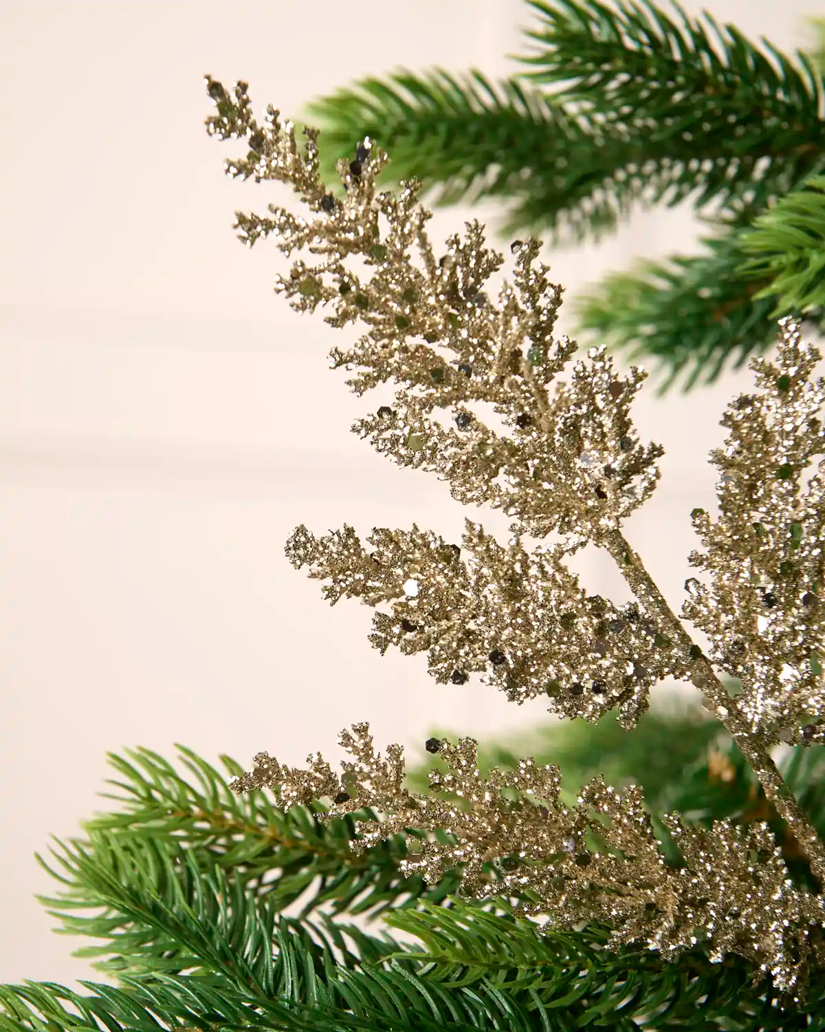 Close-up of a latte glitter leaf pick showing sparkling foliage and reflective sequin detail.