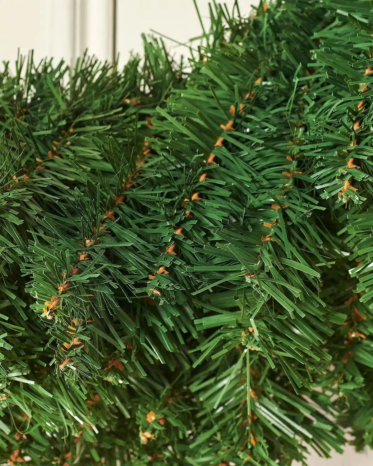Close-up of layered green branch tips on the majestic Christmas wreath