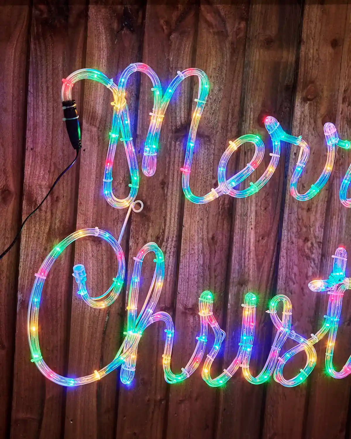 Close-up view of the 100 cm Merry Christmas rope light display with bright multi-coloured LEDs secured to a durable frame.