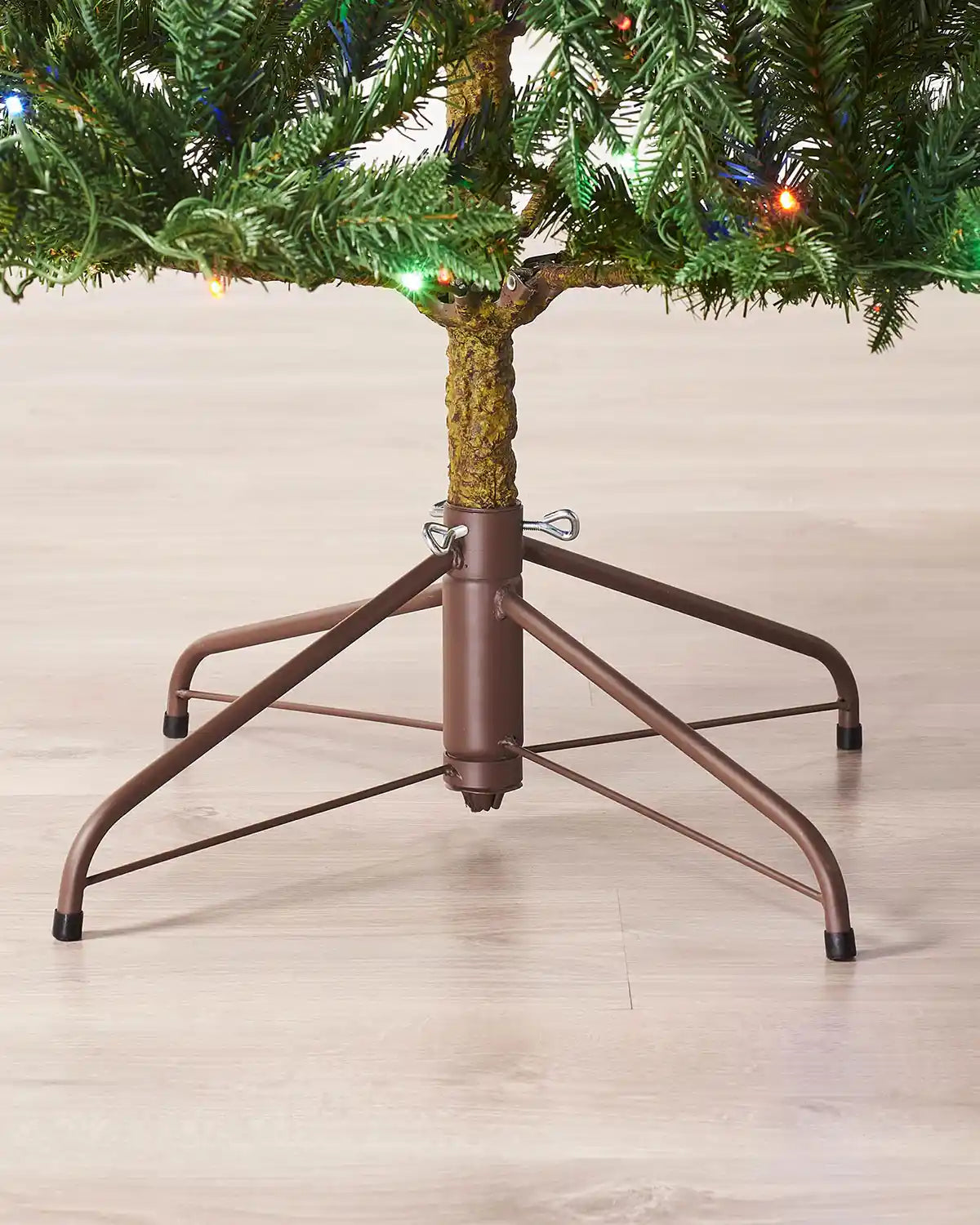Close-up of the natural bark trunk and metal stand on the Christmas tree