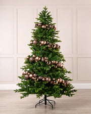 Mocha bauble garland wrapped around a green Christmas tree with shiny, matt and glitter baubles.